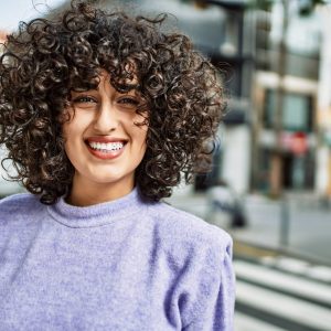 Young middle east woman smiling confident at street