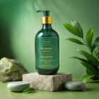 Luxury Baby Hair Rosemary Botanical Shampoo bottle with gold pump photographed outdoors on stone with green leaves and sunlight